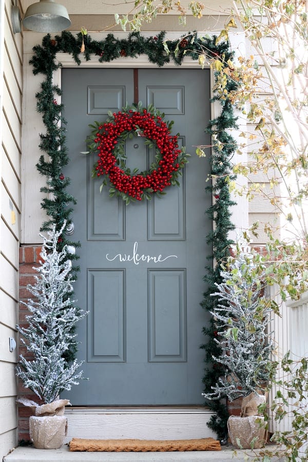 Red berry wreaths make for a welcoming statement on the Christmas porch.