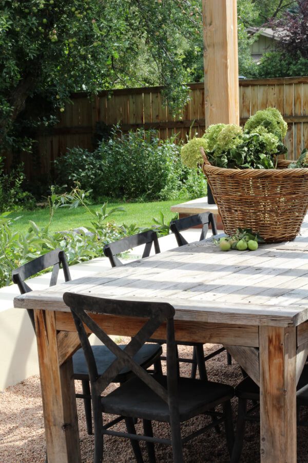 wooden outdoor table with black chairs.