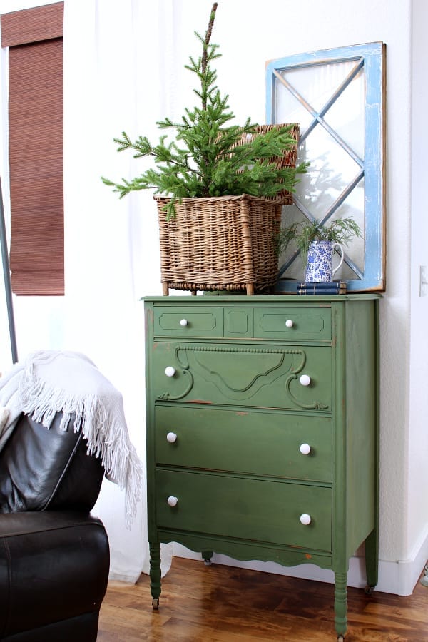 An old dresser painted Boxwood green is decorated for winter.