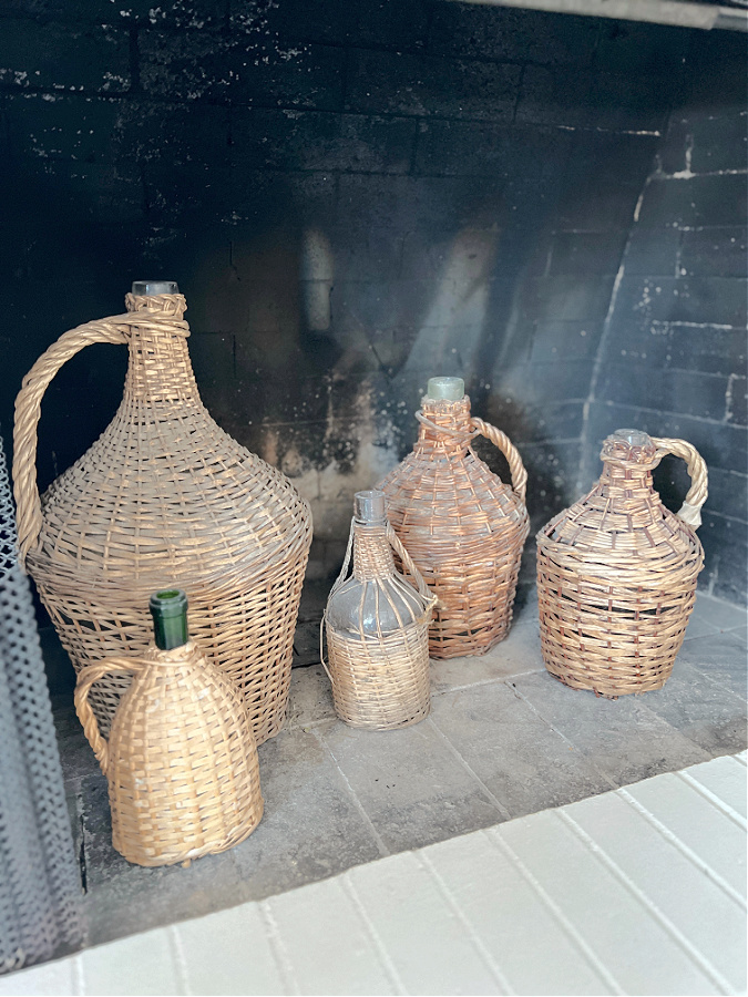 wicker demijohns in fireplace insert