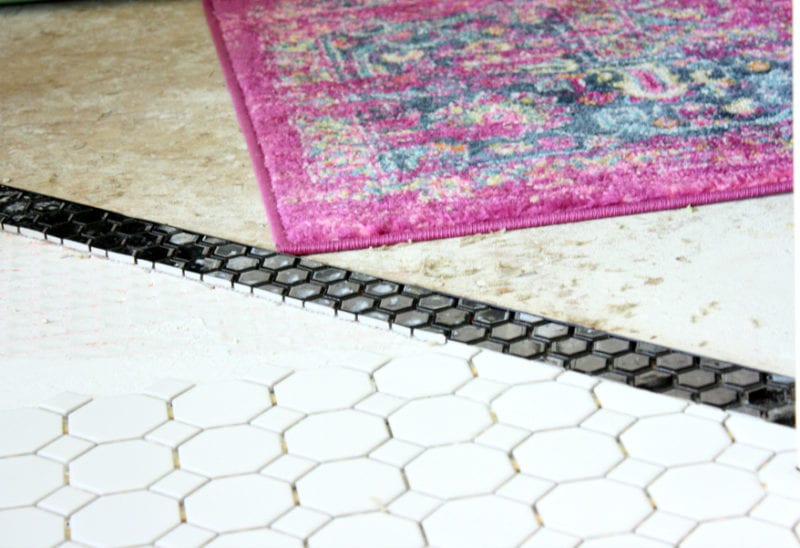 THe black strip of tile adds just the right amount of detail to the entryway.